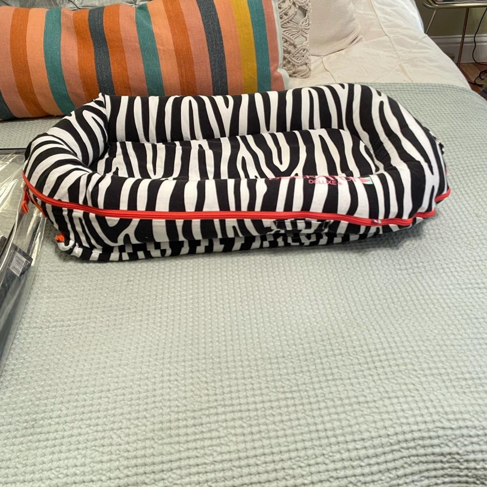 DockATot Deluxe zebra print, washable, parent fav
